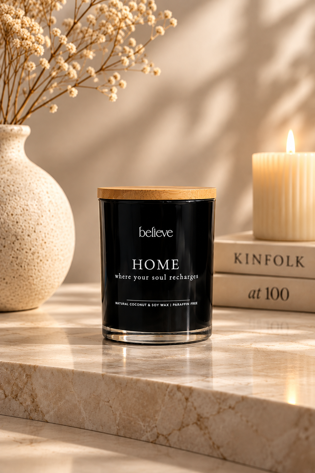 HOME candle with wooden lid on a marble ledge in warm afternoon light