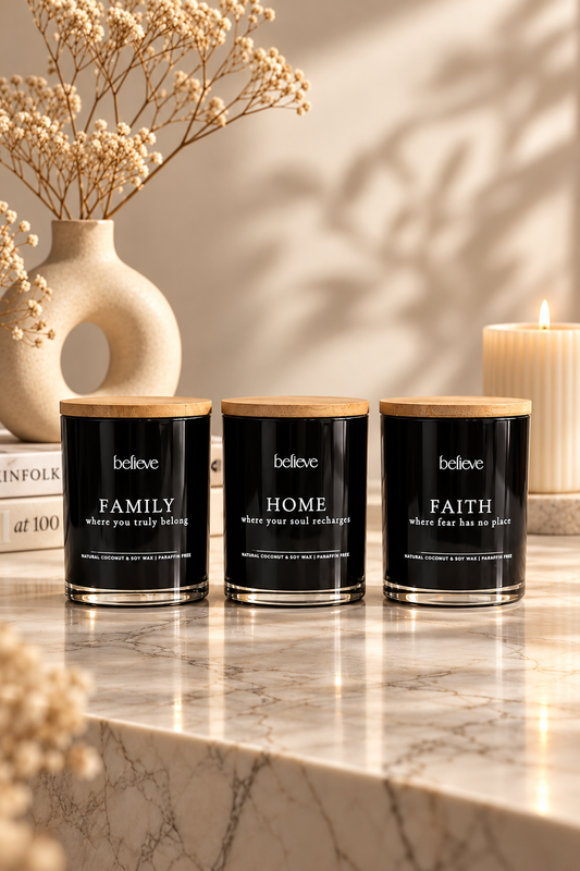 The BELIEVE Legacy Set — FAMILY, HOME and FAITH candles side by side on a marble ledge